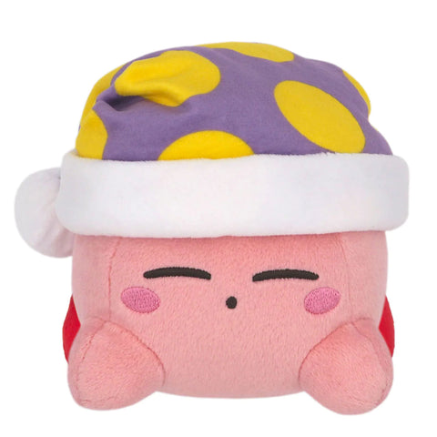 A plush of a kirby laying down with his eyes closed. He's wearing a purple nightcap with yellow spots