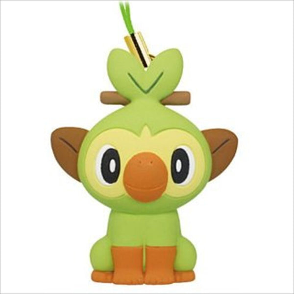 A light green and brown Grookey keychain with a green strap.