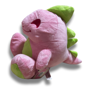 A three quarters view of the large pink dinosaur plush. His fur is a fluffy light pink, his spikes and feet are lime green, and his facial details are nicely embroidered.