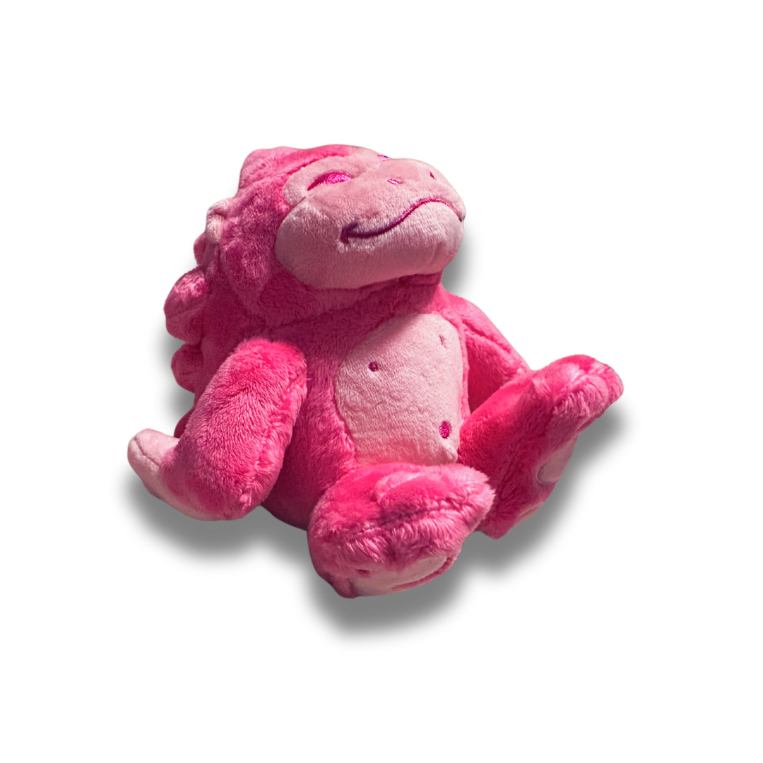 A three quarters view of the small pink gorilla plush. His fur is a fluffy bright pink and his facial details are nicely embroidered.