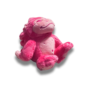 A three quarters view of the small pink gorilla plush. His fur is a fluffy bright pink and his facial details are nicely embroidered.