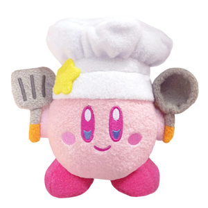 A super fuzzy kirby plushie wearing a chef hat and holding a spatula and frying pan. His facial details are nicely embroidered and he's smiling.