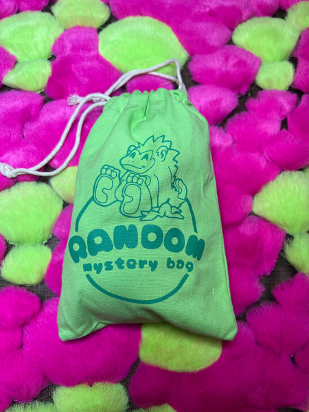 Image of a random mystery bag. The bag is green with a pink gorilla logo on it.