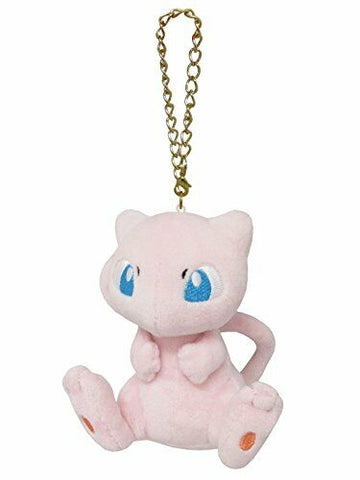 Small pink mew plush with blue eyes and a gold hanging chain.