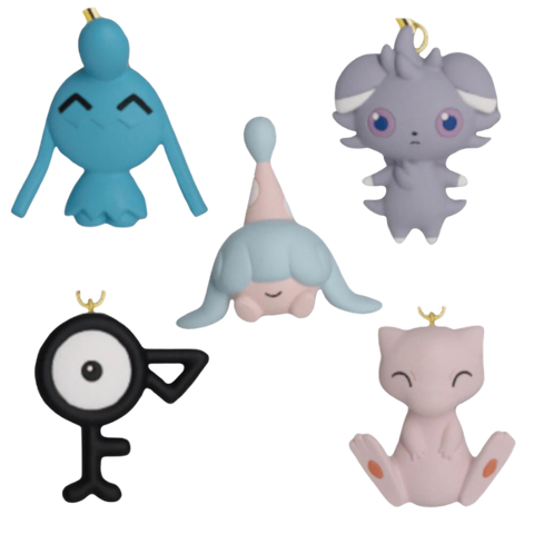 An image of all five psychic type pokemon keychains. In the top left is Wynaut, top right is Espurr, bottom right is Mew, bottom left Unown, and middle Hatenna.