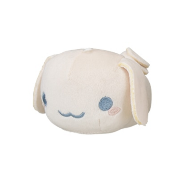 A plush of Cinnamoroll in light sepia tones. He is squat and barrel shaped with no limbs.