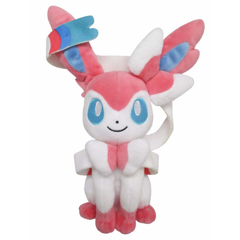Detailed, high quality plush of Sylveon in a seated position. They have embroidered light blue eyes and pink, white, and blue ribbon details.