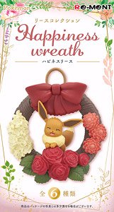 The front of the box for a Happiness Wreath box. It features the eevee figure, relaxing on a white, red, pink, and brown wreath with a big red bow.