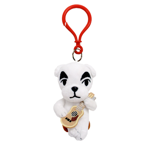 A mini plush of KK slider, dangling by a red plastic clip. His face is nicely embroidered and he is holding a felt guitar and sitting on a plush brown stool.