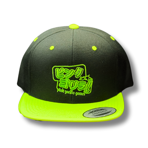 A black flatbilled hat with a neon green brim, neon green embroidery that says Pink Gorilla in katakana and pink gorilla games in small english text.