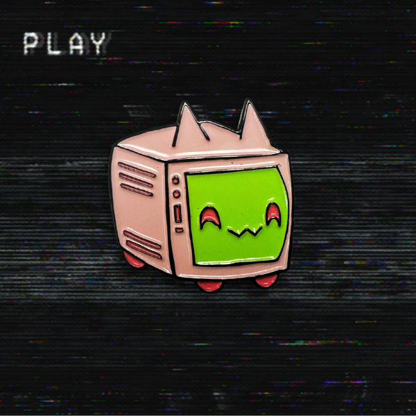 An enamel pin of CaTV, a TV with cat ears and feet. The body of the TV is light pink, with bright pink feet. The screen is the cat's face and is bright green. She has a happy mischievous facial expression. The pin is on a TV scanline background, but this is not part of the product.