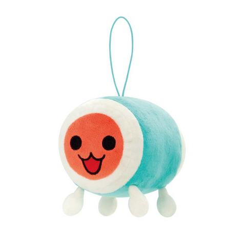 A soft plush of Don from Taiko Drum Master. His body is blue and white, and his face is an orange-ish red, and he has an open mouth smile.