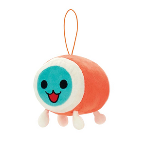A soft plushie of Katsu from Taiko Drum Master. Has a red-orange body with white feet, and a blue face with a happy open mouth smile.