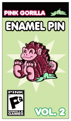 A pink glittery enamel pin of our Pink Gorilla logo, on a light green pin backing. It says Pink Gorilla Enamel Pin, Vol. 2.