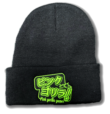 A black cuffed beanie with lime green embroidery. The embroidery is Japanese characters that read "Pink Gorilla", with english text that says "Pink Gorilla Games" underneath.