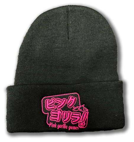 A black cuffed beanie with bright pink embroidery. The embroidery is Japanese characters that read "Pink Gorilla", with english text that says "Pink Gorilla Games" underneath.